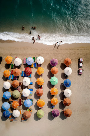 Generative AI illustration of Colorful beach umbrellas on a sunny day from above view. holidays conceptの素材
