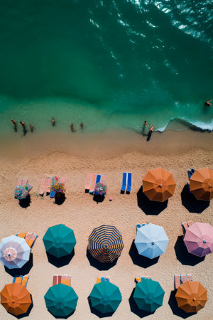 Generative AI illustration of Colorful beach umbrellas on a sunny day from above view. holidays conceptの素材