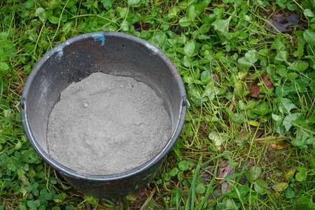 bucket full of wood ash for use in the garden. grassy backgroundの写真素材