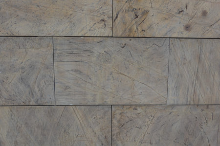 Detailed view of stone tiles with visible scratches and natural patterns, arranged in a rectangular...