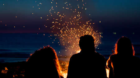 Friends with fire in beachの写真素材