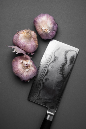 Fresh garlic and knife viewed from aboveの写真素材