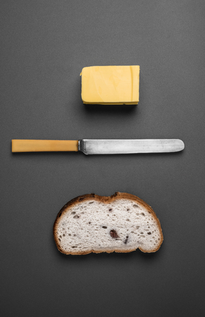 Bread and butter - knife, butter and bread viewed from aboveの写真素材