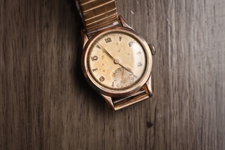 Vintage wristwatch on a wooden table. Classic watchの写真素材