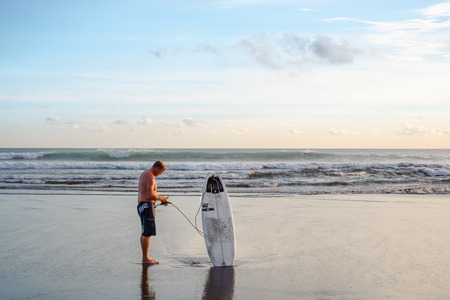 Bali,  Indonesia Ã¢ï¿½ï¿½ May 22,  2012 : A surfer prepares to go surfing.のeditorial素材