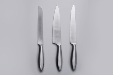 Stainless steel kitchen knife isolated over white background, set of three objectsの写真素材