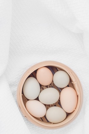 Fresh chicken eggs in basketの写真素材
