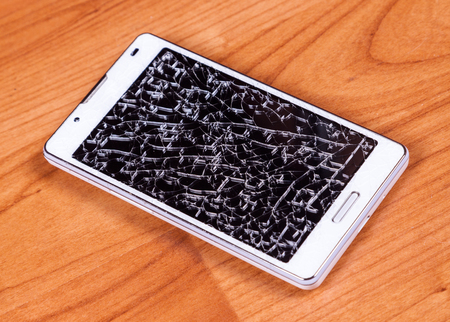 broken mobile phone on wood groundの写真素材