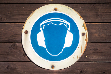 blue ear muff symbol on wood textureの写真素材