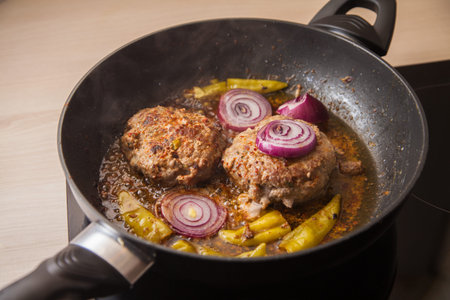 two meat burger fries in a pan