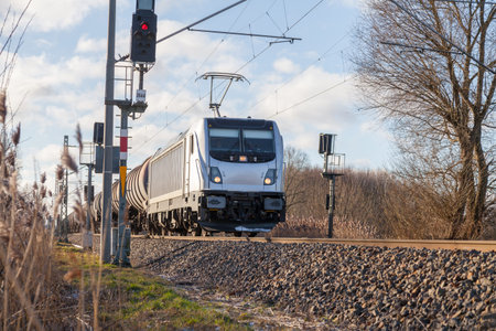 german cargo train drives on tracks to freight yard