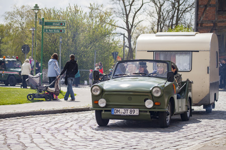 ALTENTREPTOW / GERMANY - MAY 1, 2015: german trabant car with trailer drives on a street at oldtimer show on may 1, 2015 in altentreptow, germany.のeditorial素材