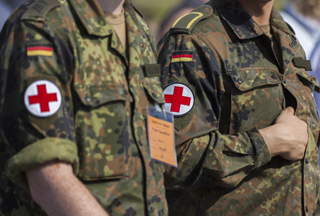 BERLIN / GERMANY - JUNE 3, 2016: two german army soldiers with a red cross brassardのeditorial素材