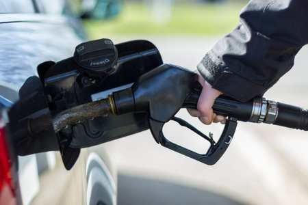 hand on a gas pump nozzle