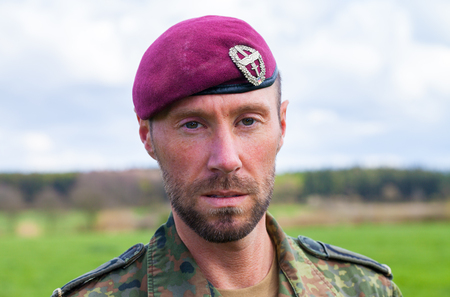 german soldier with a beret stands on a field backgroundの写真素材