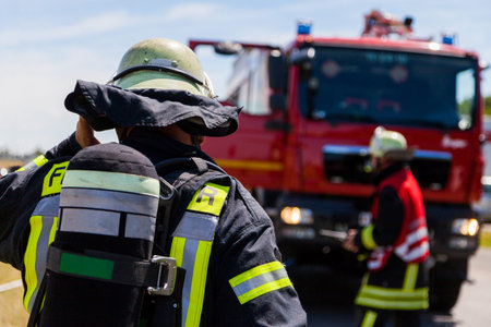 german fireman ( Feuerwehr ) stands near an accident