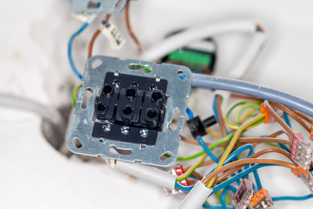 an open wall socket on construction siteの写真素材