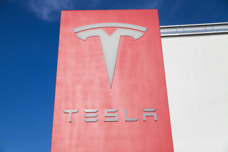 FUERTH / GERMANY - MARCH 4, 2018: Tesla logo near a car dealer. Tesla, Inc. is an American company...