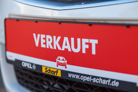 NUERNBERG / GERMANY - MARCH 4, 2018: German word verkauft, sold on a car tag at an Opel car dealer in Germany. Opel Automobile GmbH is a German automobile manufacturer.のeditorial素材