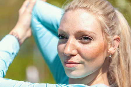 Young woman is stretching in a sport dressの写真素材