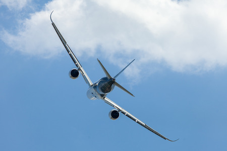 BERLIN / GERMANY - APRIL 28, 2018:  Airbus A350 XWB plane flies at airport Berlin / Schoenefeld. The Airbus A350 XWB is a family of long-range, twin-engine wide-body jet airliners.のeditorial素材