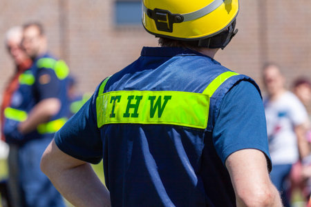 Delmenhorst / Germany - May 6, 2018: German technical emergency service sign on a vest from a man. THW, Technisches Hilfswerk means technical emergency service.のeditorial素材