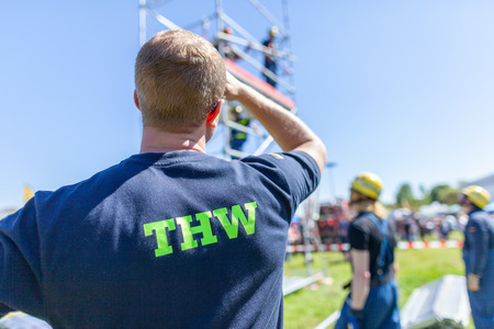 Delmenhorst / Germany - May 6, 2018: German technical emergency service sign on a vest from a man. THW, Technisches Hilfswerk means technical emergency service.のeditorial素材