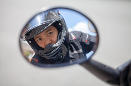 Woman with a black helmet on a motorbikeの写真素材