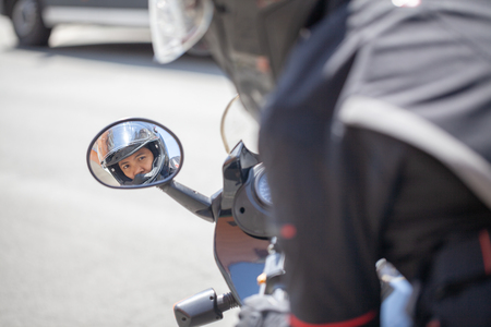 Woman with a black helmet on a motorbikeの写真素材