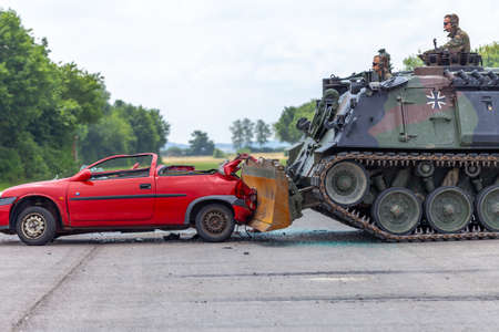 FELDKIRCHEN / GERMANY - JUNE 9, 2018: German tank dozer Dachs crashes a red car on day of the Bundeswehr in Feldkirchen.のeditorial素材