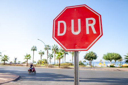 Turkish Stop sign on a street near the beach. DUR is the turkish word for stop.のeditorial素材