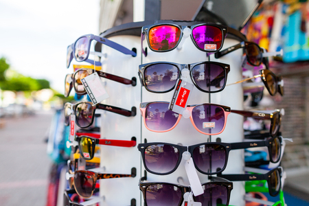 ALANYA / TURKEY - SEPTEMBER 30, 2018: Sunglasses from Ray-Ban hangs on a stand at a local market in Alanya.のeditorial素材