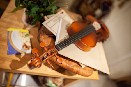 A violin lies on a small tableの写真素材