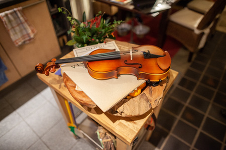 A violin lies on a small tableの写真素材