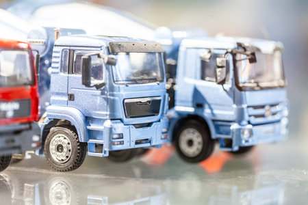 Miniature trucks stand in a glass cabinet
