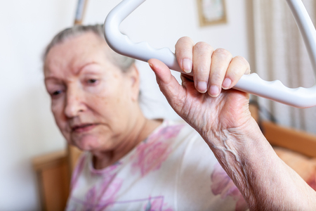 An old woman pulls herself up on a gallowsの写真素材