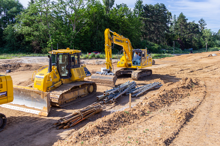 HANOVER / GERMANY - JUNE 2,2019: Komatsu excavator and other construction vehicles stands on a construction site in Hanover.のeditorial素材