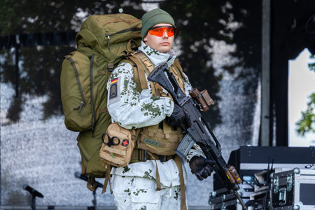 AUGUSTDORF / GERMANY - JUNE 15, 2019: German mountain trooper in snow camouflage suit walks on a...