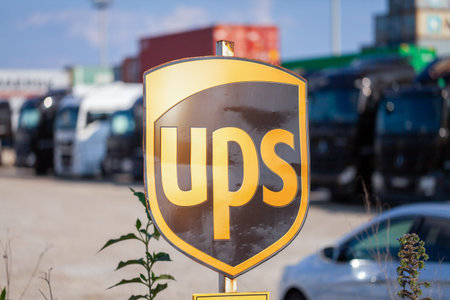 NUREMBERG / GERMANY - AUGUST 4, 2019: Company sign from the American multinational package delivery, United Parcel Service (UPS), stands near container terminal in Nuremberg.