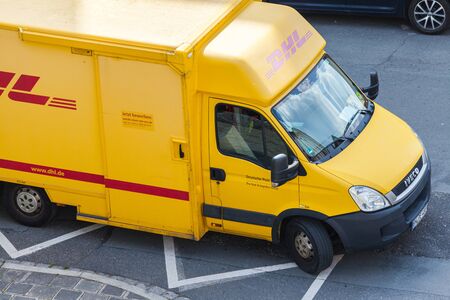 FUERTH / GERMANY - JULY 18, 2019: Iveco transporter from international courier, parcel, and express mail company DHL, stands on a street.のeditorial素材
