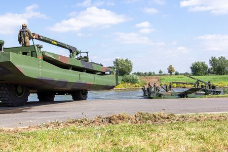 MINDEN / GERMANY - SEPTEMBER 4, 2019: German tank pioneer battalion trained a tank crossing over a river with M3 Amphibious Rig. The M3 Amphibious Rig is a self-propelled amphibious bridging vehicle.のeditorial素材