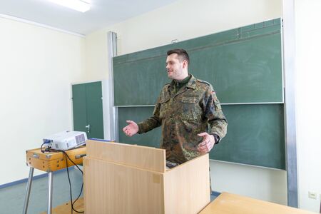 German soldier stands in a classroom . German word Bundeswehr, means german army.の写真素材