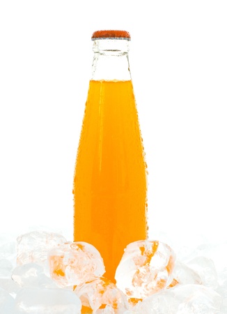 Orange juice In a bottle on the ice background の写真素材