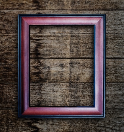 Old picture frame on vintage wood wall.の写真素材