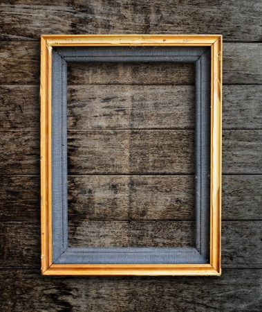 Old picture frame on vintage wood wall の写真素材