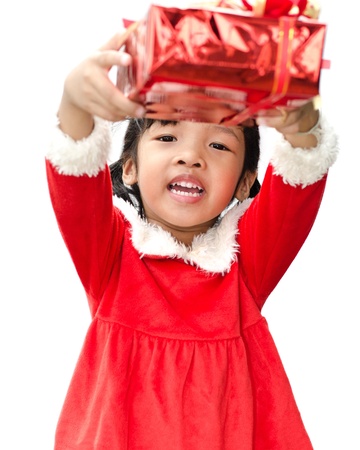 little girl dressed as Santa Claus with christmas gift の写真素材