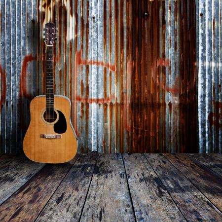 Guitar in grunge room の写真素材