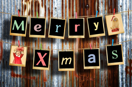 Merry christmas words hanging on clothesline on grunge background.の写真素材