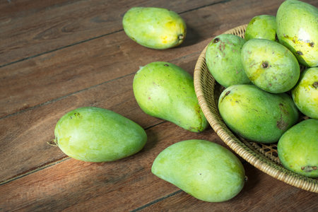 Mango on wood background with sunlight.の写真素材