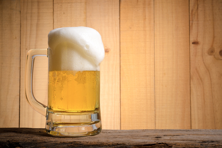 Beer glass on wood background.の写真素材